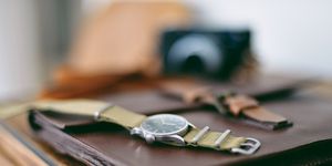 Military wristwatch on wooden cabinet
