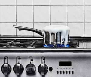 milk boiling over in pan