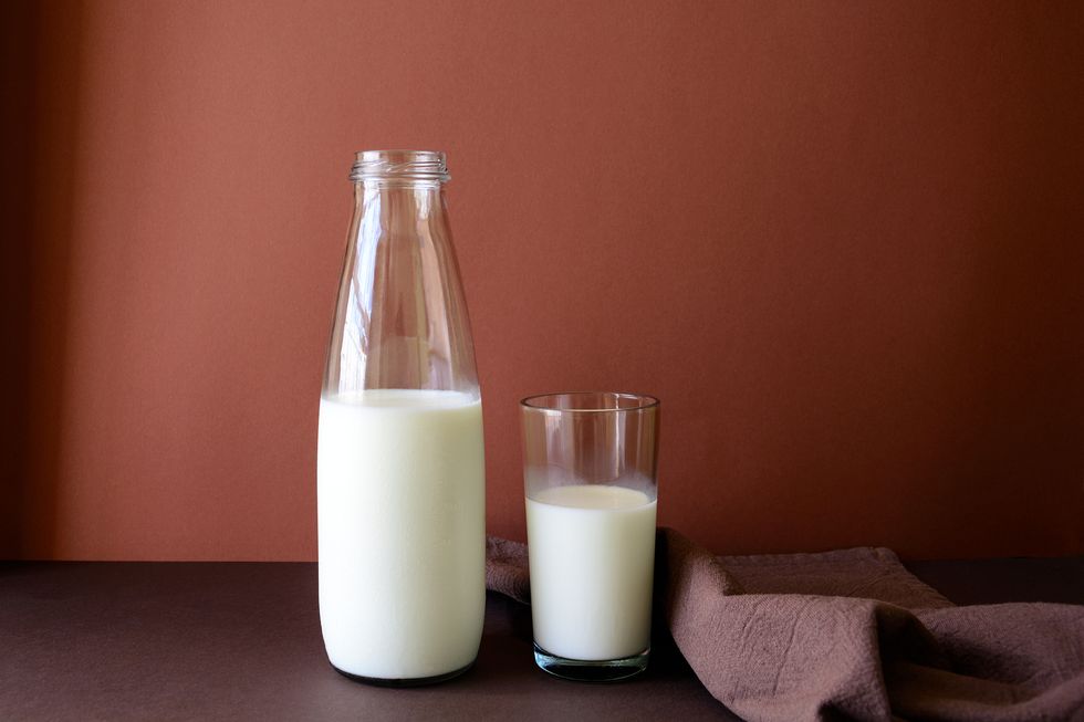 milk bottle and milk glass on brown paper background healthy eating concept