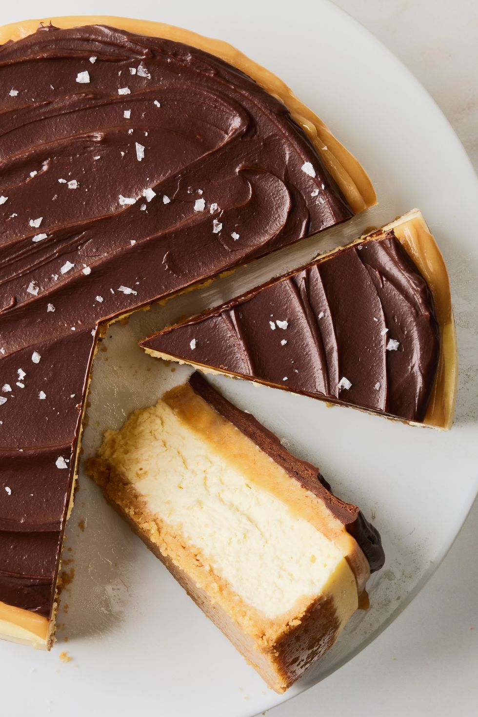 layered shortbread cheesecake covered in chocoalte