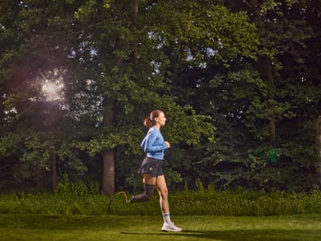 milly pickles running against a backdrop of trees