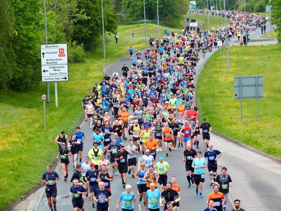 a large group of people running on a road