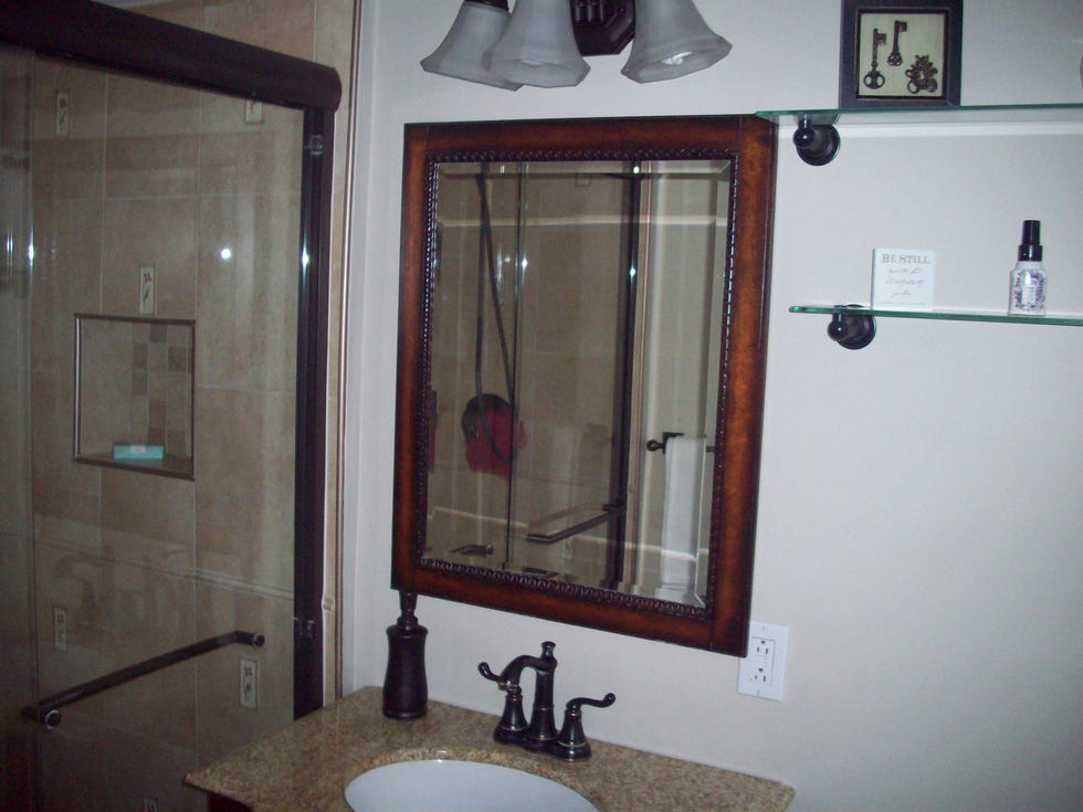 a bathroom with a mirror and a sink