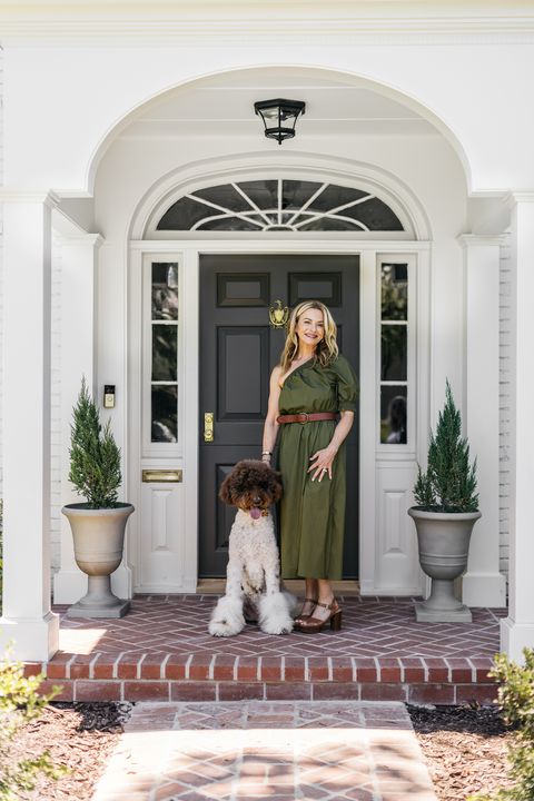 mindy lavender and dog in front of house entrance