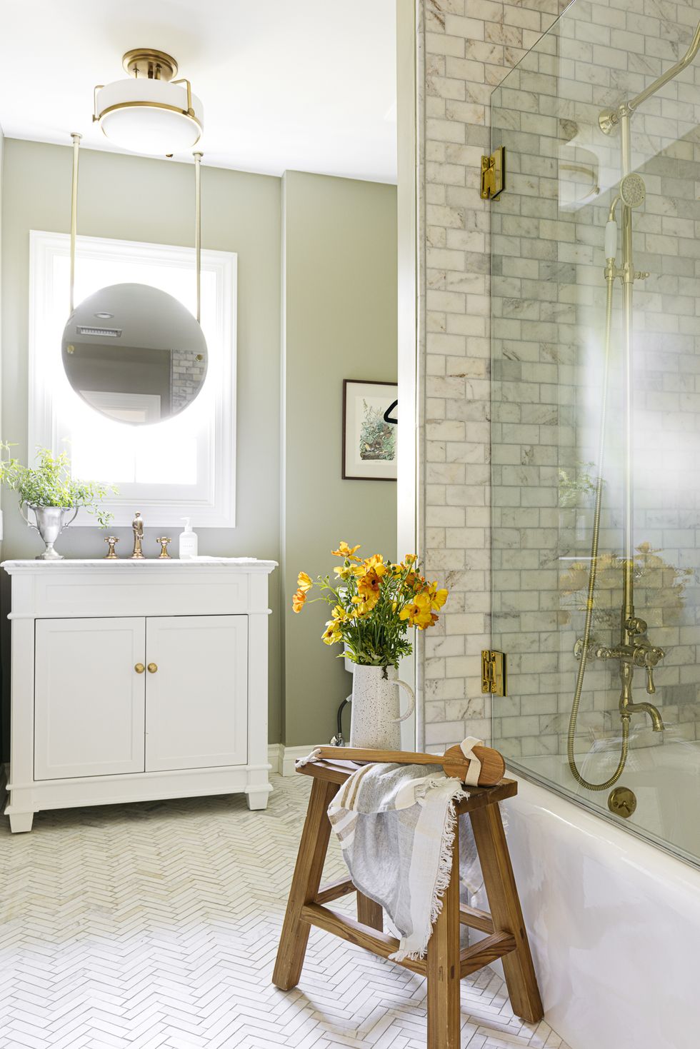 shower, vanity, and round mirror in bathroom