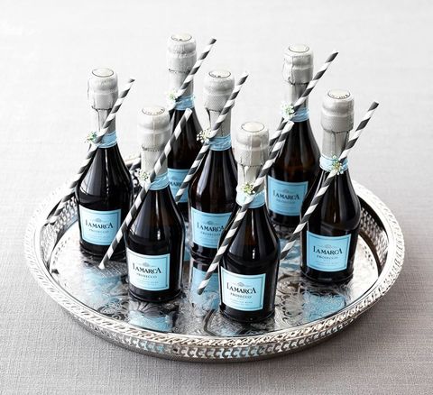 mini bottles of la marca champagne on a circular silver tray