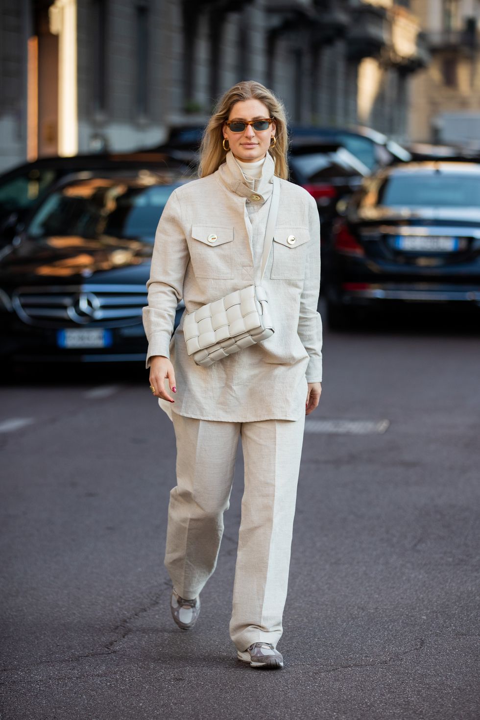 milan, italy   february 22 a guest is seen wearing bottega bag, creme white jacket and pants outside ferragamo during milan fashion week fallwinter 2020 2021 on february 22, 2020 in milan, italy photo by christian vieriggetty images