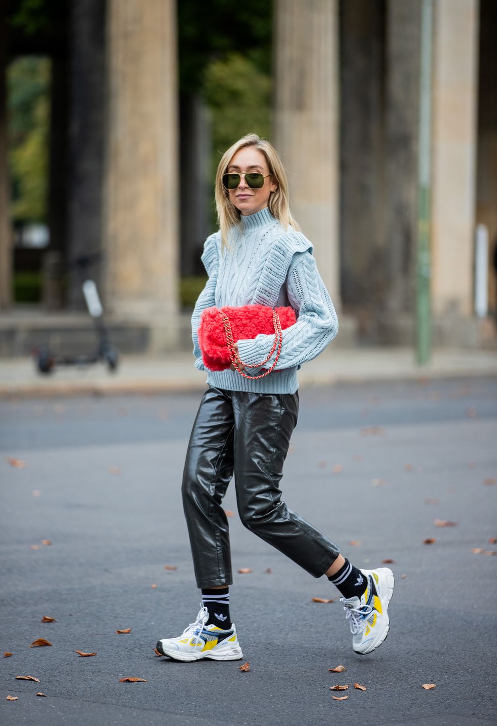 berlin, germany   october 13 sonia lyson is seen wearing axel arigato sneaker, black socks with logo print adidas, black pants and blue knit edited, red chanel bag, sunglasses bottega veneta on october 13, 2020 in berlin, germany photo by christian vieriggetty images
