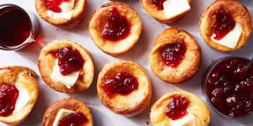 mini cranberry popovers topped with butter, cranberry sauce, and syrup