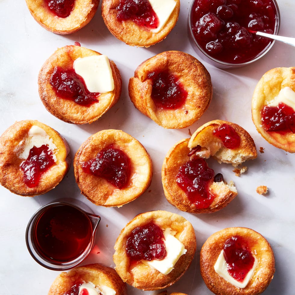 mini cranberry popovers topped with butter, cranberry sauce, and syrup