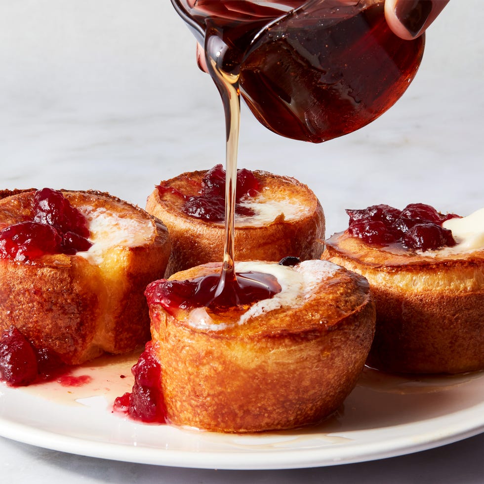 mini cranberry popovers topped with butter, cranberry sauce, and syrup