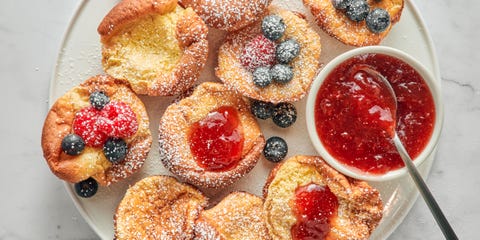 mini dutch baby pancakes with berries jam and confectioners sugar