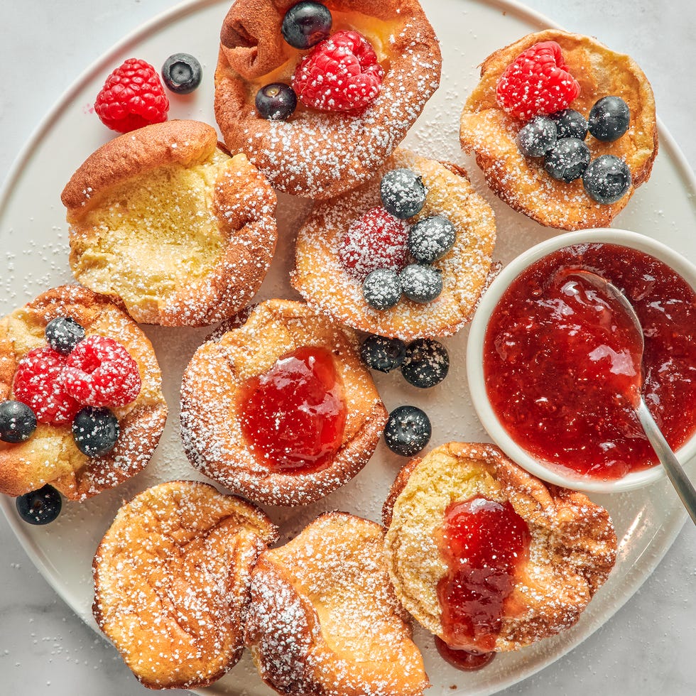 Mini Dutch pancakes with raspberry jam and confectioners' sugar