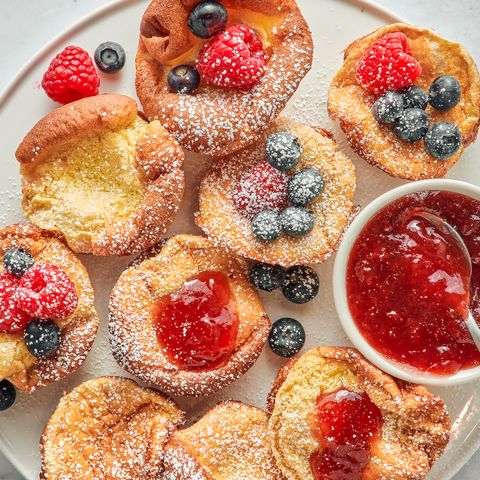 mini dutch baby pancakes with berries jam and confectioners sugar
