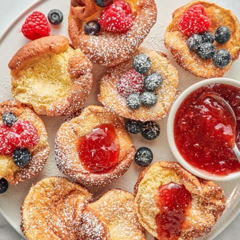 mini dutch baby pancakes with berries jam and confectioners sugar