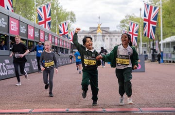 children cheering as they cross the finish line of a running event on the mall in london