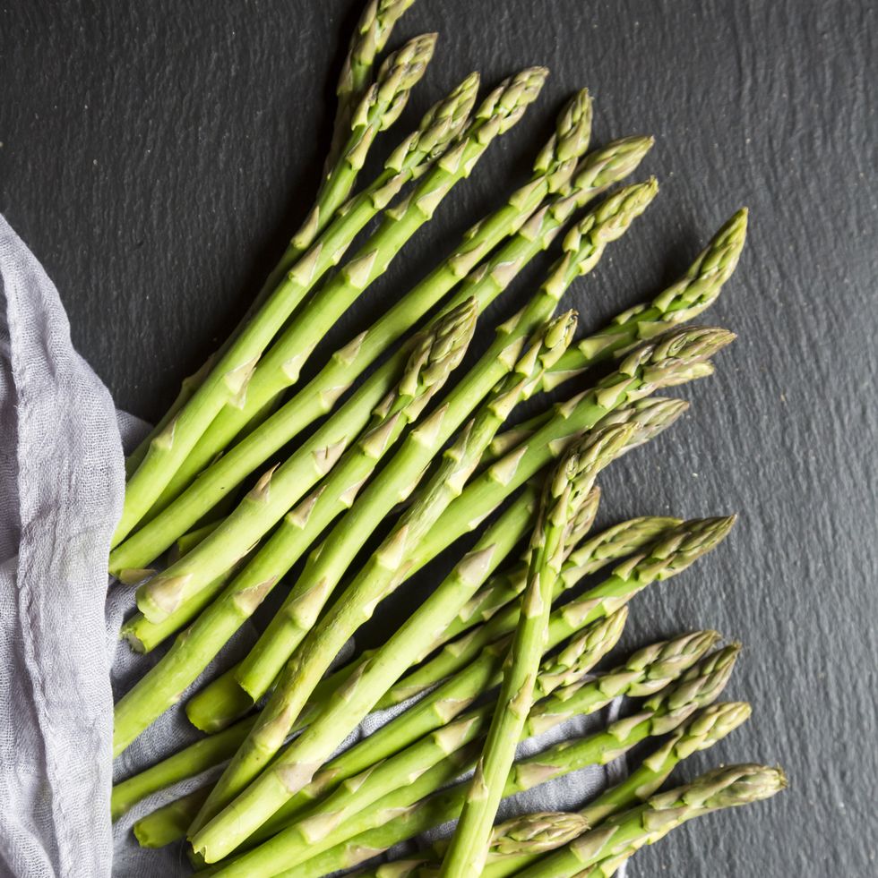 mini organic green asparagus on slate