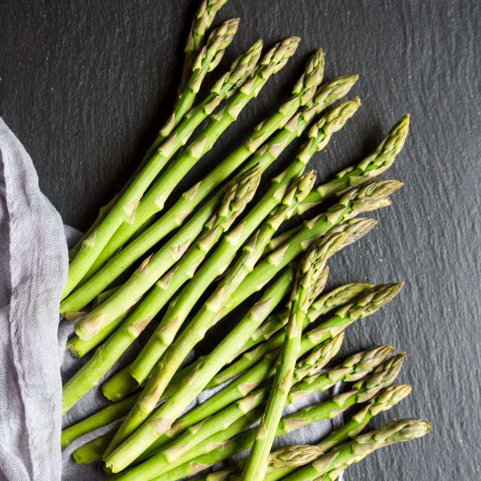 mini organic green asparagus on slate