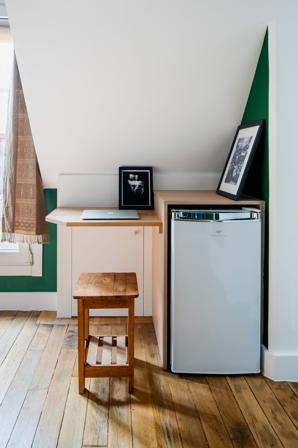 Nevera y pequeño escritorio construido con una balda de madera