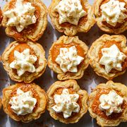 mini pumpkin pies topped with whipped cream and shaved milk chocolate