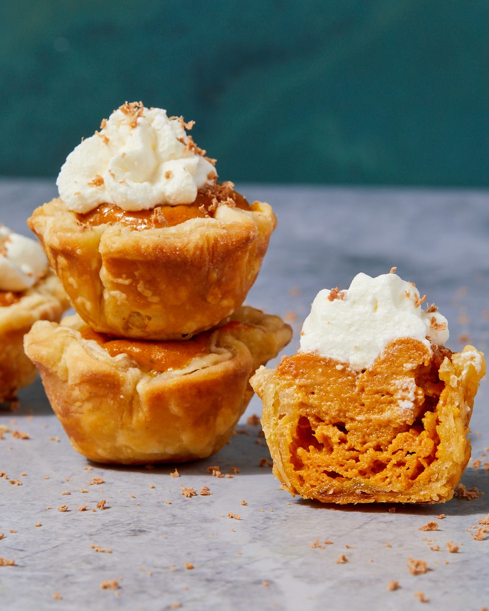 mini pumpkin pies topped with whipped cream and shaved milk chocolate