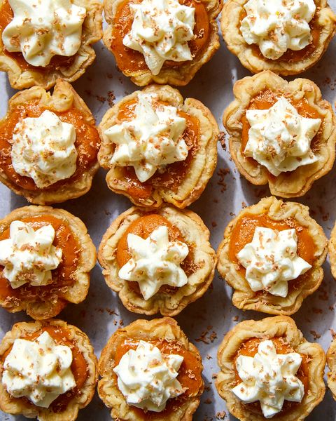 mini pumpkin pies topped with whipped cream and shaved milk chocolate