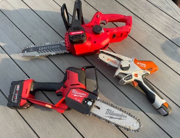 three mini chainsaws placed on a wood deck