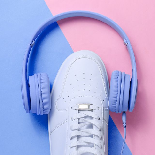 minimalism music lover  headphones, white sneakers on blue pink pastel background top view flat lay