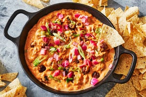 mini meatball skillet dip garnished scallion and red onion