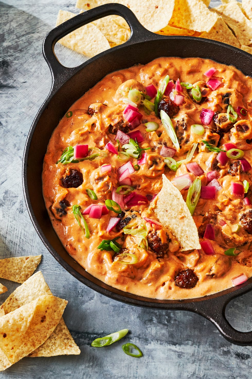 mini meatball skillet dip garnished scallion and red onion