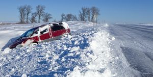 Minivan Stuck in a Snow Filled Ditch along Highway
