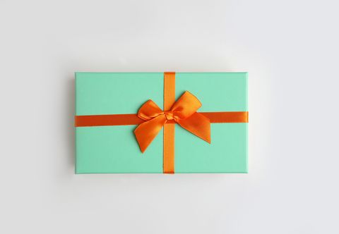 mint color gift box with orange ribbon on white background isolate, copy space
