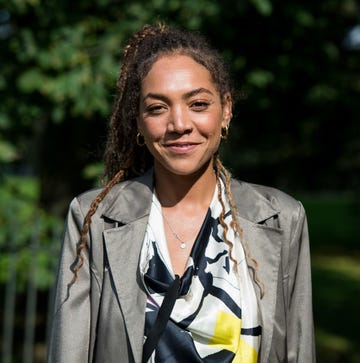 miquita oliver wearing a grey jacket and patterned shirt