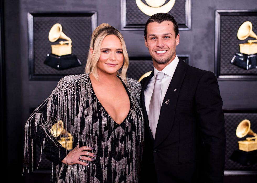miranda lambert and brendan mcloughlin pose together while standing, they both wear black formal attire