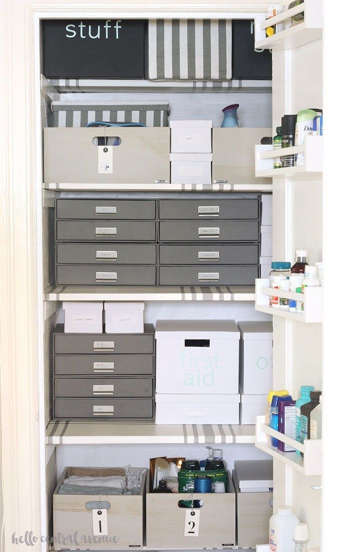 organizing linen closet: hamper, drawers, totes, hanging rack