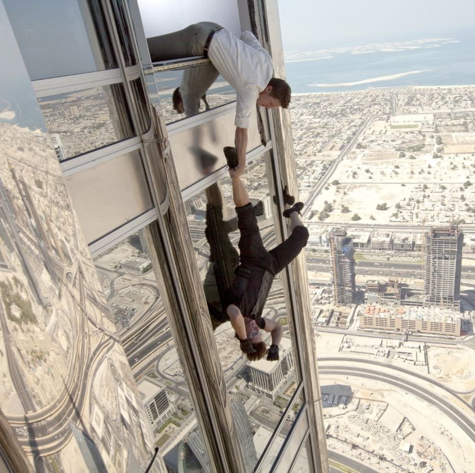 benji dunn hangs on to ethan hunt, who dangles out the window high up in the burj khalifa, in a scene from mission impossible ghost protocol it is the fourth film if you're watching the mission impossible movies in order