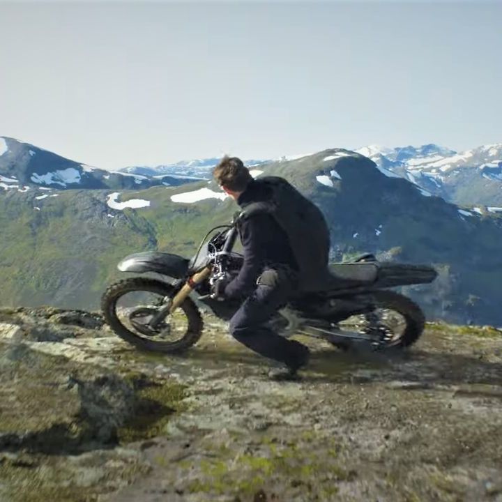 ethan hunt rides a motorcycle to the edge of a cliff in a scene from mission impossible dead reckoning part one dead reckoning part two is the eighth film if you're watching the mission impossible movies in order, and it will come out in 2024