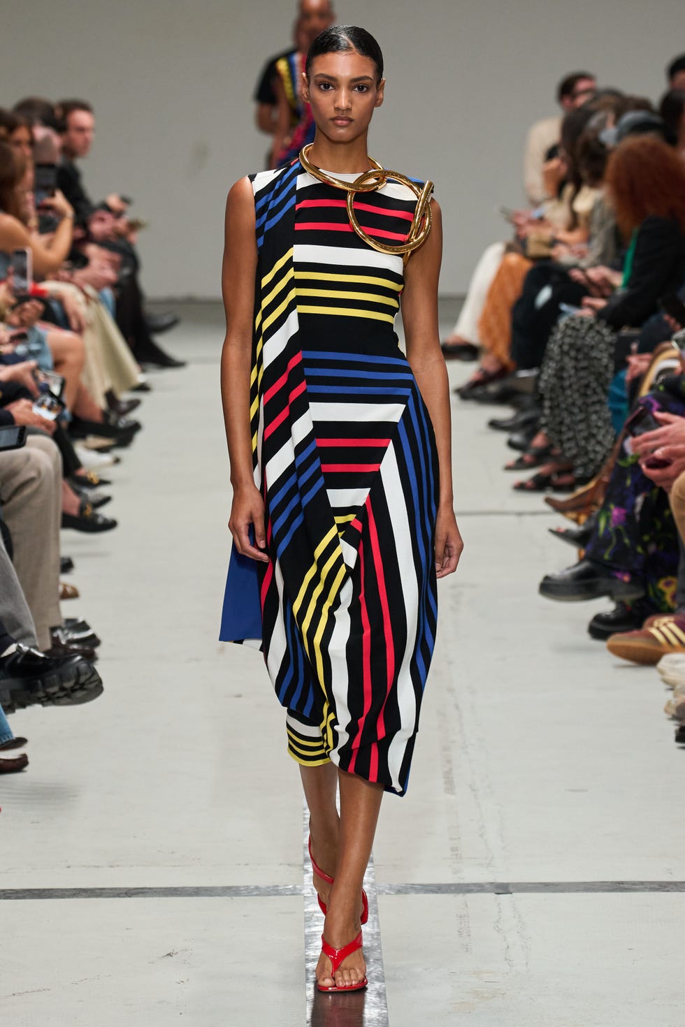 Model showcasing a striped dress on a runway