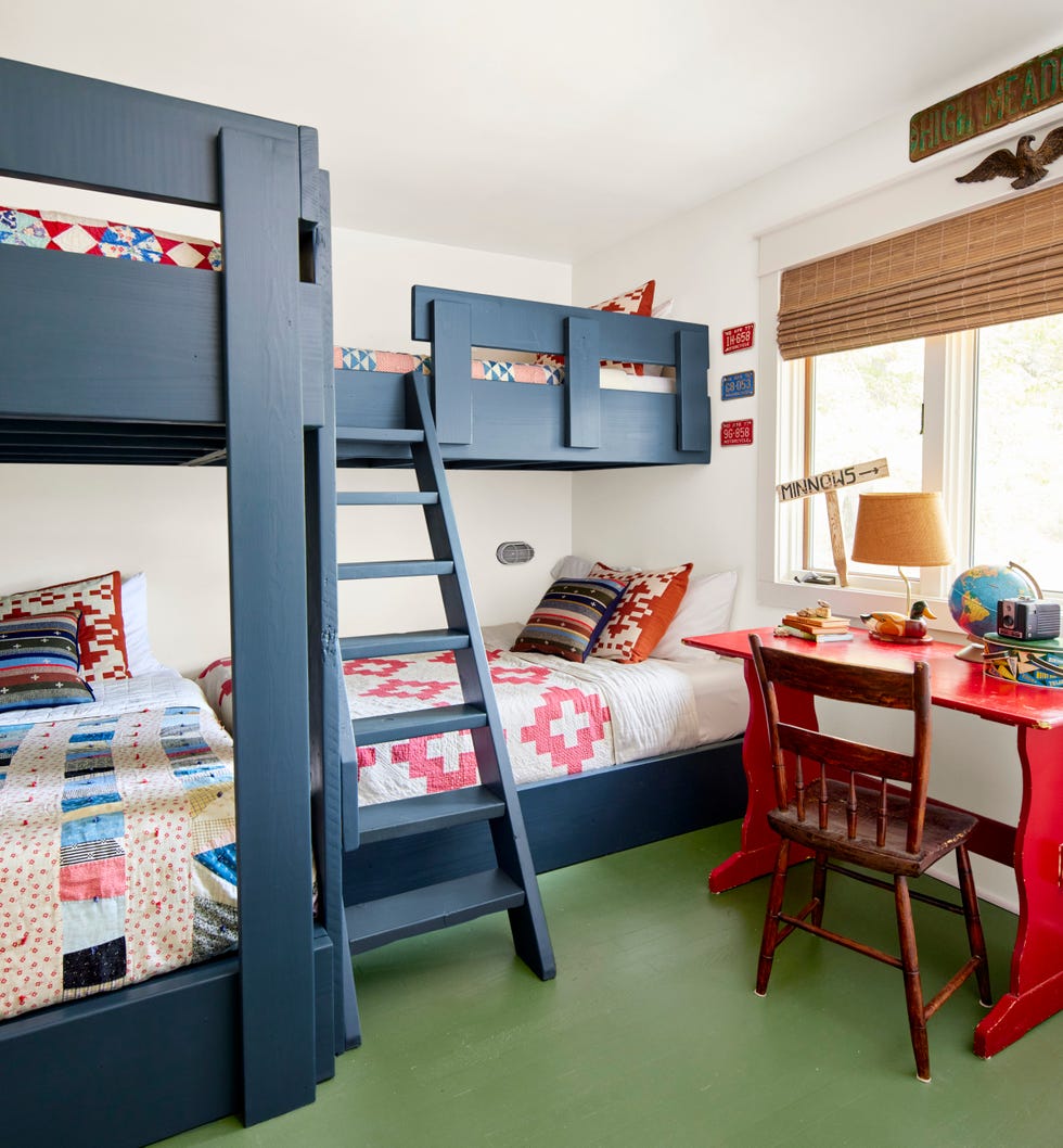 lake cabin bunk room with blue built in bunk beds and a green floor