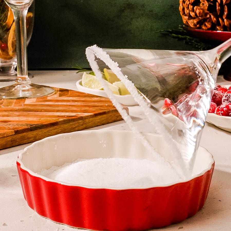 martini glass rimmed with salt over a dish of salt