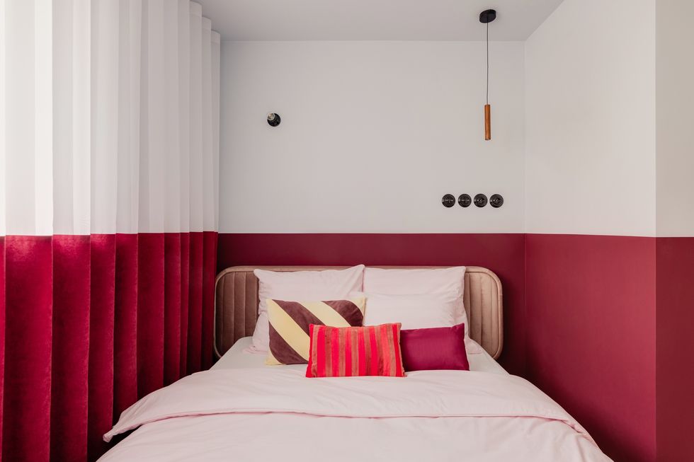 a bed with red curtains