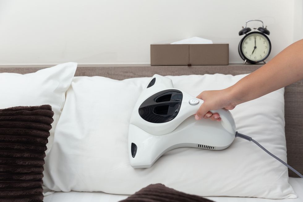 a vacuum cleaner being used on a pillow