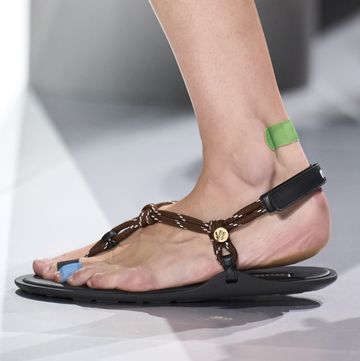 a woman's feet wearing high heeled shoes