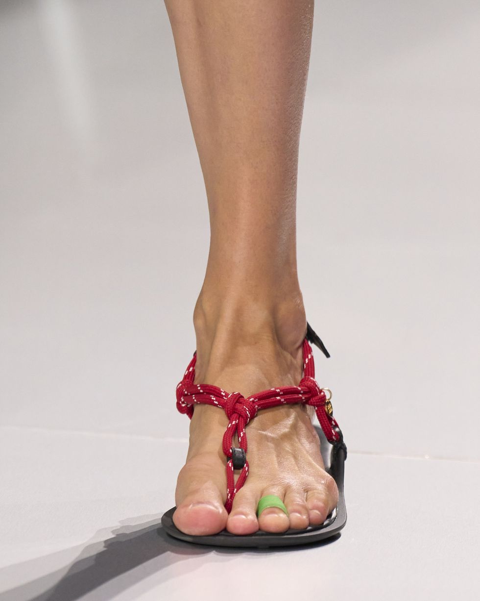 a person's feet wearing high heeled shoes