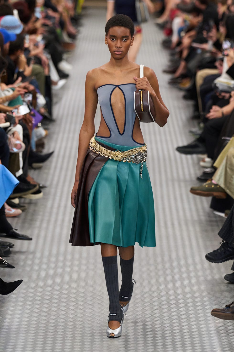 Fashion model showcasing a unique clothing design on the runway