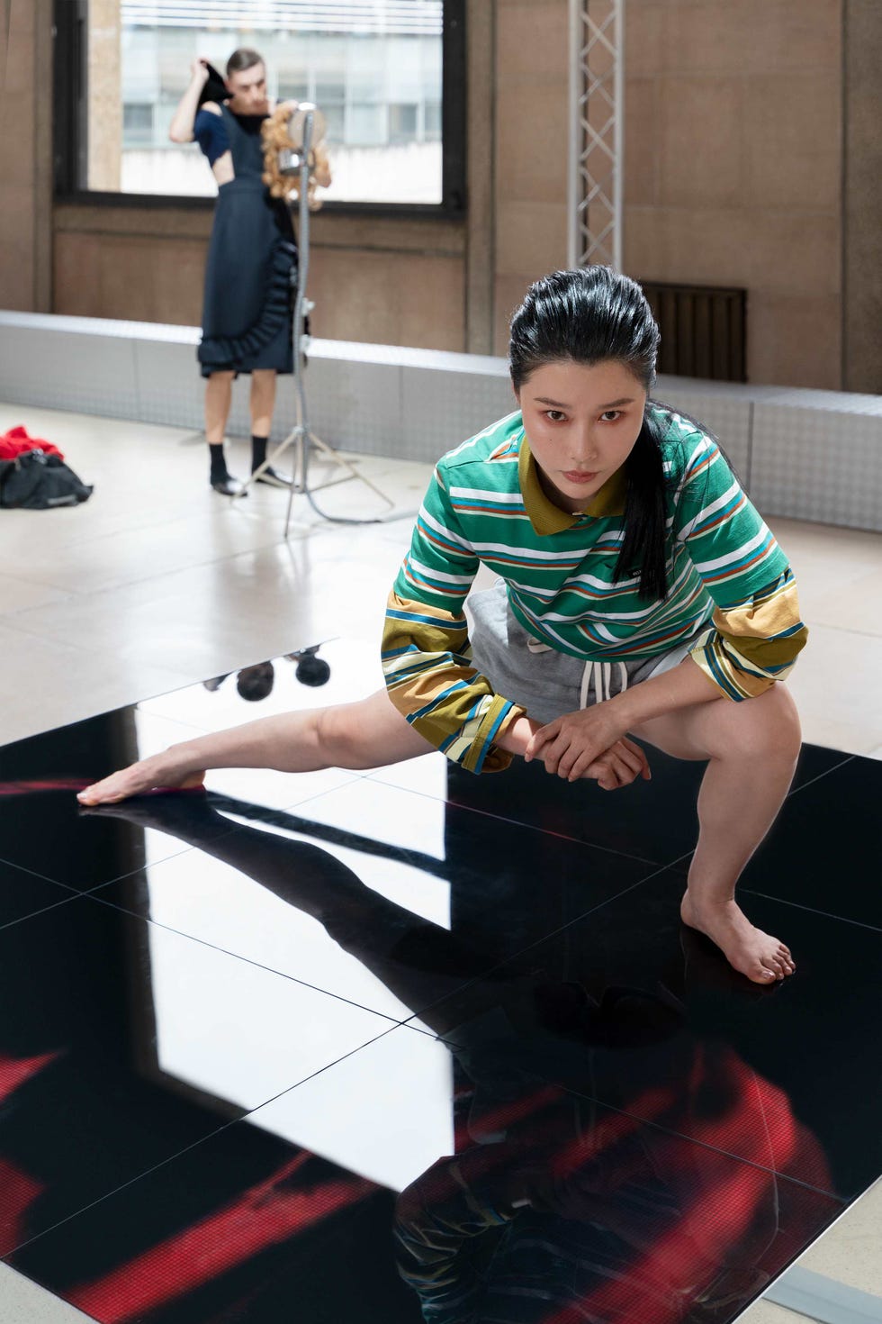 a person is engaged in a stretching pose seated with one leg extended and the other bent