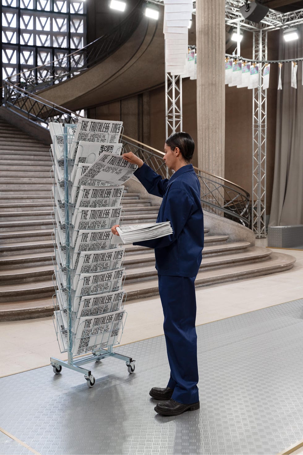 woman grabs newspapers at exhibition