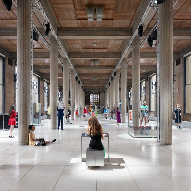 an expansive gallery space featuring several figures positioned throughout an expansive gallery space featuring several figures positioned throughout