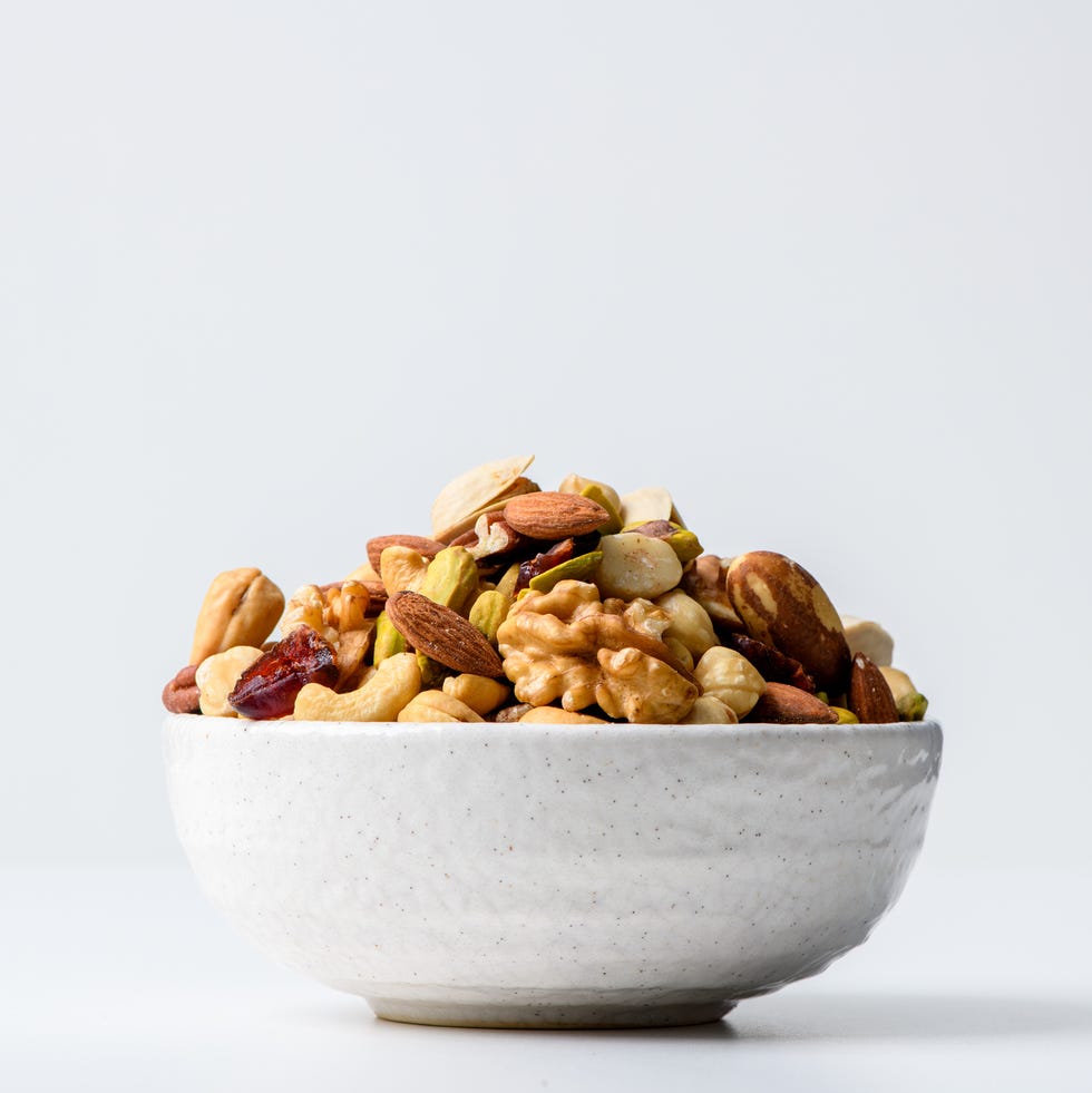 Mix nuts and dry fruits in a bowl with white background mix nuts and dry fruits in a bowl with white background
