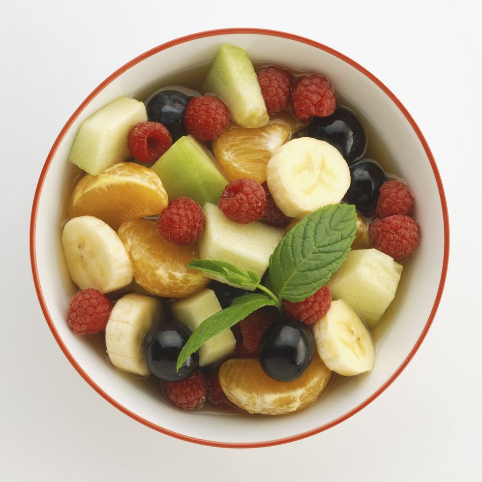 Mixed fruit salad in bowl, view from above.